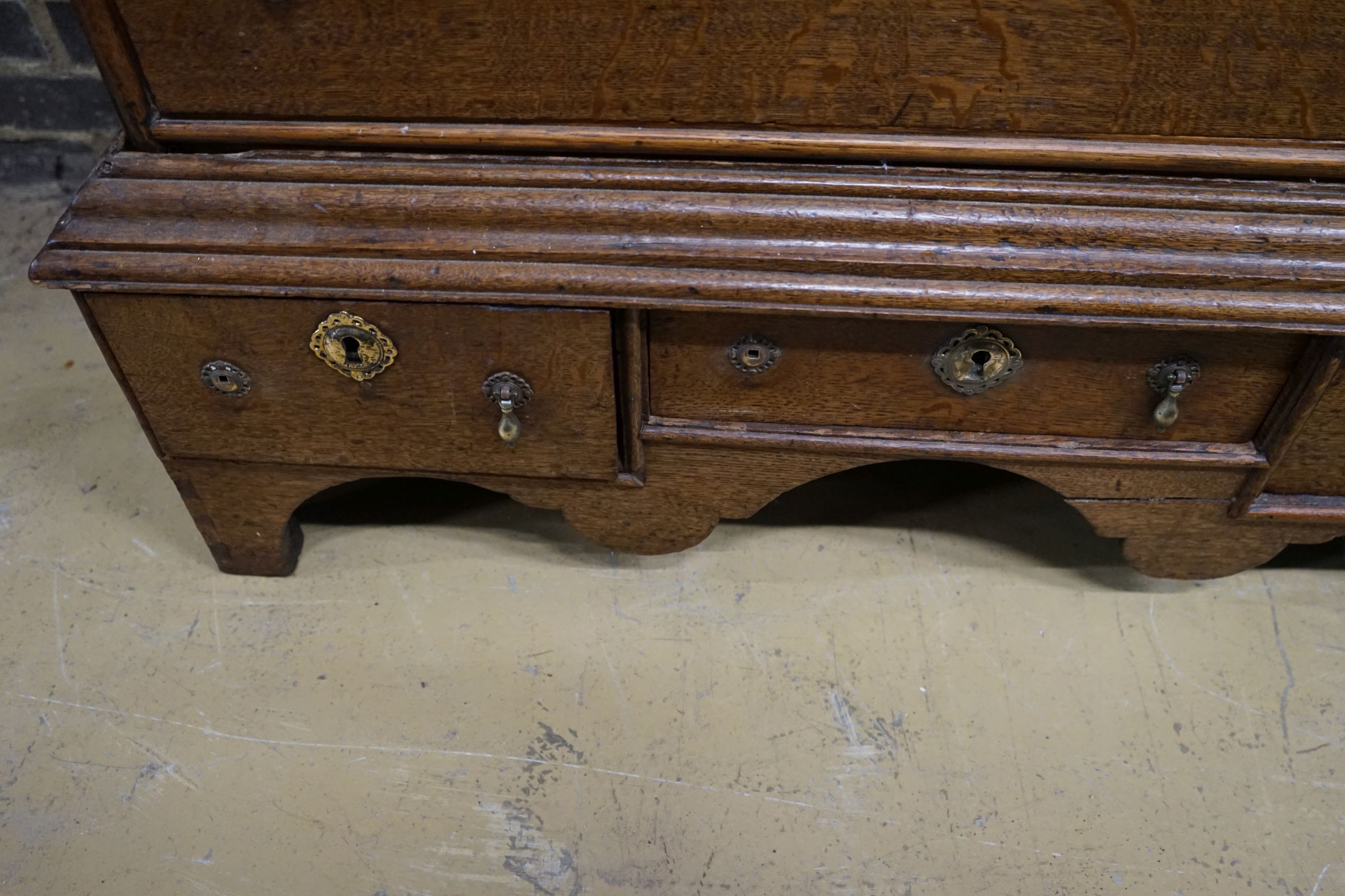 An 18th century oak chest on stand, width 104cm, depth 56cm, height 133cm